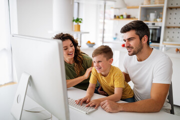 Fototapeta premium Parents helping to children studying online at home. Lockdown and online school, technology concept.