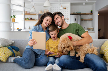 Happy family having fun time, playing together at home with dog