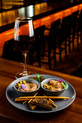 Meat liver pate on toasted bread with fruit seeds on brown table