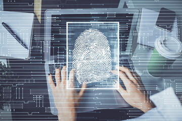 Double exposure of woman hands typing on computer and fingerprint drawing. Security concept.