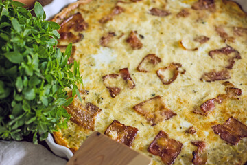 French onion pie with bacon in a baking dish, copy space. Authentic hobby homemade cakes, jellied pie with onions