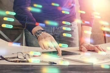 Double exposure of man's hand holding and using a digital device and data theme drawing. Technology concept.