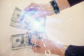 Multi exposure of technology drawing hologram and us dollars bills and man hands. Data concept