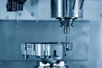 The 4-axis simultaneous machining center tapping the motorcycle gear case parts on the  rotary table. The hi-precision automotive manufacturing process by multi-axis CNC milling machine.