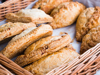 Assorted organic pasties and sausage rolls on sale at a farmers market