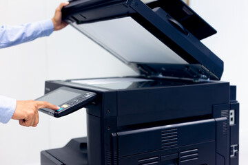 Bussiness man Hand press button on panel of printer, printer scanner laser in office copy machine...