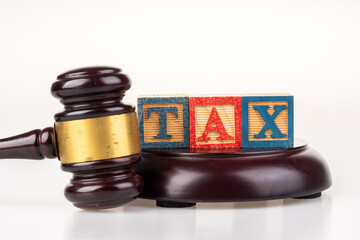 Gavel hammer and tax wooden cube with white background.