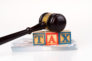 Gavel hammer and tax wooden cube with white background.