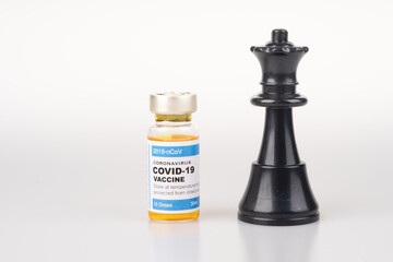 Black wqueen and vaccine bottle with white background.