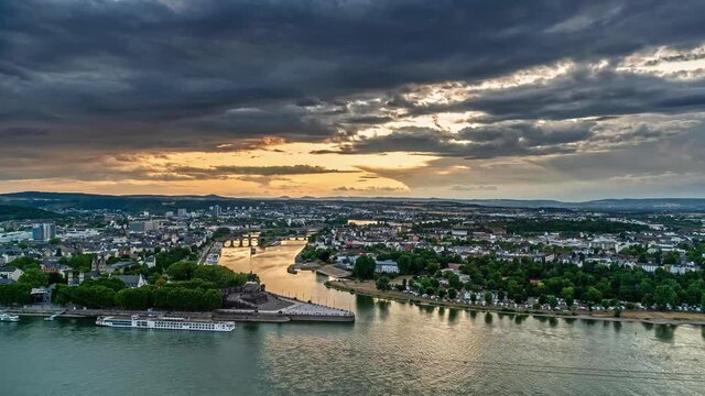 time lapse of Deutsches Eck at Koblenz, Germany at dusk. Dark clouds floating over the city