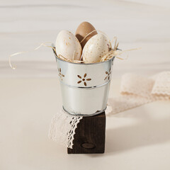 Easter beige spotted eggs in a bucket. Easter background. Copy space.