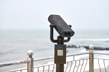 Coin-operated binocular viewer looking out to sea - Powered by Adobe