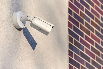 IP CCTV security camera on concrete wall, urban cityscape