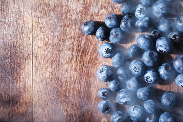 Water drops on ripe sweet blueberry. Fresh blueberries background with copy space for your text. Vegan and vegetarian concept. Macro texture of blueberry berries.