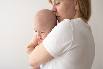 Attractive happy mother embrace kiss little baby boy. Happy family