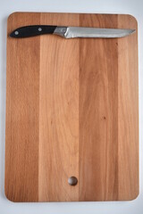 wooden cutting board with a kitchen knife,