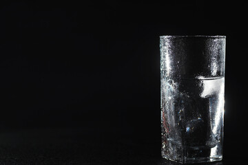 Close up pouring purified fresh drink water from the bottle on table in living room. Drinking water. Mineral vitamin water. Healthy, mineral-rich, refreshing water.