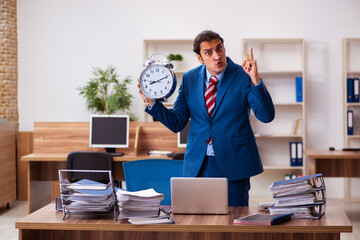 Young male employee in time management concept