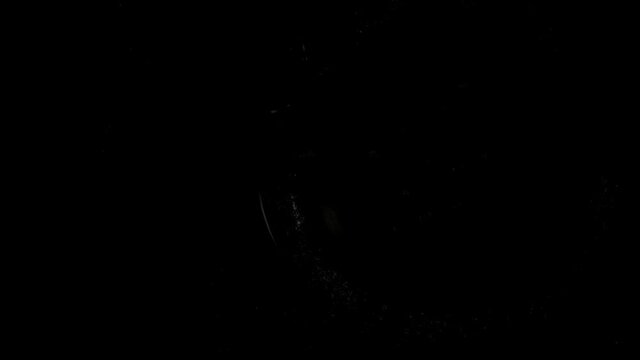 Second arrow passing by open balance on rotating swiss watch with gears and planets shiny drawings. Light is up and going out. Extreme closeup