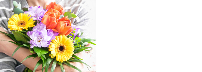 womans hands holding a beautiful bouquet of different flowers. Isolated on a white background. womens day web border or banner.