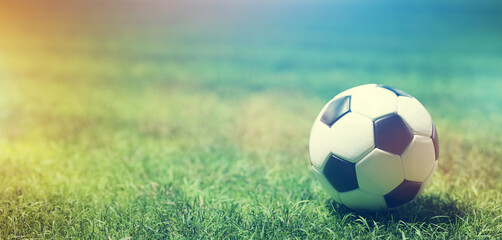 Football soccer ball on grass field