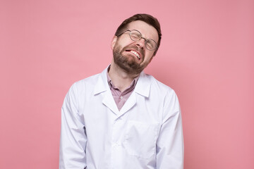 Young doctor in a white coat and round glasses is very tired, he is stressed, he closed eyes and made a miserable face. 