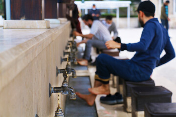 selective focus. Turkey  Bursa Ulu Mosque was built in 1399 year. local and foreign Muslim tourists prayed.