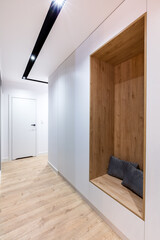 Corridor in modern design apartment with closet and seat