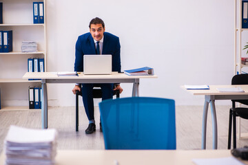 Young male employee working in the office