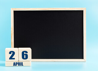 April 26th. Day 26 of month, Cube calendar with date, empty frame on light blue background. Place for your text. Spring month, day of the year concept