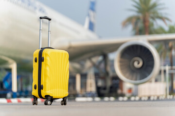 Traveler suitcase on airport and the plane blurred background, Summer vacation and travel concept.