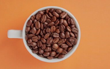 Coffee beans and a coffee cup on a colored background