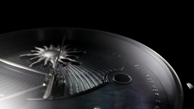 Silver second arrow running on nacrous clockface of rotating swiss made watch with moon, sun and date. Closeup of metallic details and ribbed pattern on black background