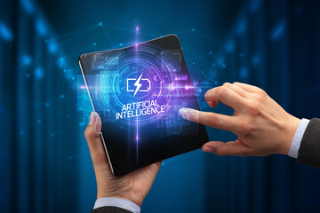 Businessman holding a foldable smartphone, technology concept