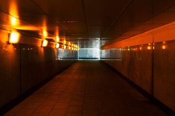 Underground passage with lanterns. Pedestrian crossing in the city. Long empty tunnel with light