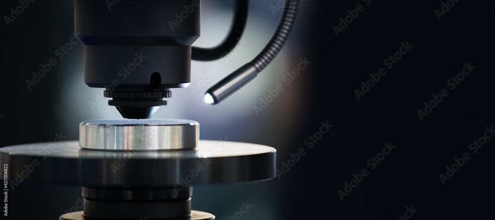 Poster microscope in laboratory. optic machine for precise measurement of part size and quality evaluation.