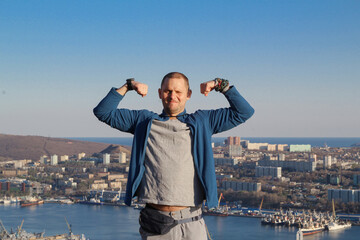 A man in a hat against the backdrop of a seascape.