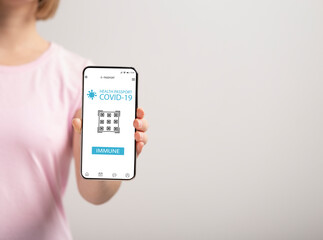 Lady showing mobile phone with Immune digital passport for covid