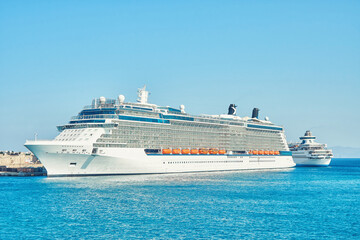 Large white tourist cruise ship on blue rippling sea