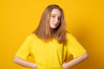 Cute teen girl. Studio image of a cute smiling young girl on yellow background.