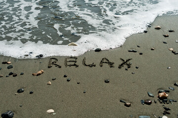 Word Relax on beach sand