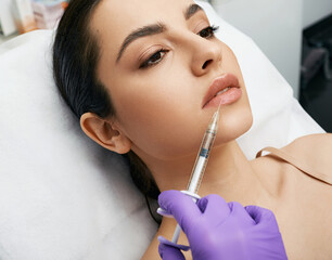 Lip augmentation procedure. Lips filler injection for beautiful woman's lip augmentation with...