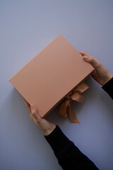 Woman hands open empty cardboard box, top view