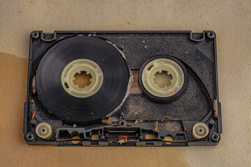 old dirty audio cassette tape on old paper background