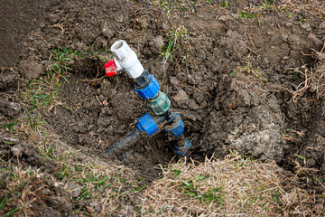 Repair and fixing concept. Busted and broken water pipe in back yard