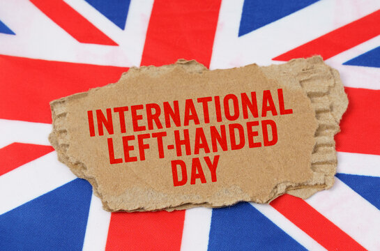 Against the background of the flag of Great Britain lies cardboard with the inscription - International left-handed day