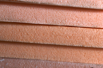 Plates of pink-colored porous insulation material