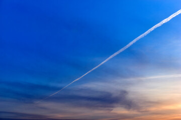 Blue evening sky and inversion trail from the plane