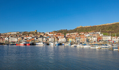Fototapeta na wymiar Harbor seafront town with castle on hill