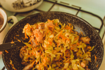 Food ingridients: meat, onion, ginger for recipe stewed beans with meat frying in a pen on a stove. Steps in cooking, process of preparing food. Concept of homemade healthy food.